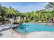Tranquil pool setting with lush landscaping, a slide feature, and inviting seating for residents and guests at 17927 Bahama Isle Cir, Tampa, FL 33647