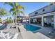 Backyard with swimming pool, patio area, comfortable seating, and lush tropical landscaping at 17927 Bahama Isle Cir, Tampa, FL 33647