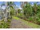 The lush backyard is perfect for gardening or outdoor entertaining at 1870 Wateroak W Dr, Clearwater, FL 33764