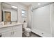 Updated bathroom featuring modern fixtures, stylish shower, and contemporary vanity with ample lighting at 1870 Wateroak W Dr, Clearwater, FL 33764