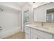 Bright bathroom with modern fixtures, tub and shower, and contemporary vanity with ample lighting at 1870 Wateroak W Dr, Clearwater, FL 33764