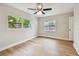 Bright bedroom with wood-look flooring, two large windows, and ample natural light at 1870 Wateroak W Dr, Clearwater, FL 33764