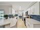 Bright kitchen with white cabinets, stainless steel appliances and beautiful blue subway tile backsplash at 1870 Wateroak W Dr, Clearwater, FL 33764