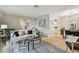 Open-concept living room with contemporary decor, stylish seating, and seamless flow to the dining area at 1870 Wateroak W Dr, Clearwater, FL 33764