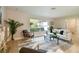 Bright living room with large windows, stylish furniture, and a neutral color palette at 1870 Wateroak W Dr, Clearwater, FL 33764