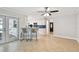 Open-concept living room with tile flooring, open access to kitchen, and access to outdoor living space at 1870 Wateroak W Dr, Clearwater, FL 33764
