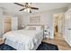 Comfortable main bedroom with ceiling fan, plush rug, and access to attached bathroom at 1870 Wateroak W Dr, Clearwater, FL 33764