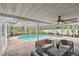 Relax on this screened patio with comfortable seating overlooking the pool at 1870 Wateroak W Dr, Clearwater, FL 33764