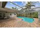 Enjoy this sparkling screened in pool and covered patio with brick pavers at 1870 Wateroak W Dr, Clearwater, FL 33764