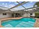 Enjoy this sparkling screened in pool and covered patio with brick pavers at 1870 Wateroak W Dr, Clearwater, FL 33764