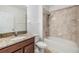 Bathroom includes a shower-tub, brown granite countertop, and modern fixtures at 18981 Alfaro Loop, Spring Hill, FL 34610