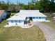 Single-story home with a white tile roof and neatly manicured lawn at 1929 New Bedford Dr, Sun City Center, FL 33573