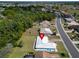 Aerial view of home in a suburban community with mature trees and lush landscaping at 1929 New Bedford Dr, Sun City Center, FL 33573