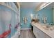 Bathroom featuring a flamingo-themed shower curtain and coordinated decor at 1929 New Bedford Dr, Sun City Center, FL 33573