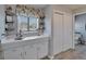 Bright bathroom featuring a vanity area and a window with floral patterned valance at 1929 New Bedford Dr, Sun City Center, FL 33573