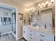 Bathroom showcasing a double vanity with quartz countertops and a glass-enclosed shower at 1929 New Bedford Dr, Sun City Center, FL 33573