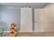 Bedroom with decorative baskets and barn slider door at 1929 New Bedford Dr, Sun City Center, FL 33573