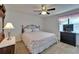 Bedroom features flamingo-themed bedding and a dark dresser at 1929 New Bedford Dr, Sun City Center, FL 33573