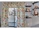 Bedroom with floral curtains offers a glimpse of the Florida room and a display of decorative stuffed animals at 1929 New Bedford Dr, Sun City Center, FL 33573