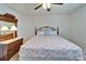 Bedroom with a flamingo-themed comforter and antique dresser at 1929 New Bedford Dr, Sun City Center, FL 33573