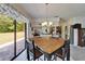 Cozy dining area with sliding door access to outdoor patio and a view of the kitchen at 1929 New Bedford Dr, Sun City Center, FL 33573