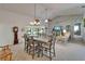 Large open dining and living area with vaulted ceilings, stone accent wall and lots of natural light at 1929 New Bedford Dr, Sun City Center, FL 33573