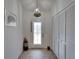 Inviting entryway with decorative front door, coat closet and unique light fixture at 1929 New Bedford Dr, Sun City Center, FL 33573