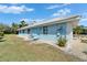Side view of the home featuring clean lines, a tidy yard, and a fresh paint job at 1929 New Bedford Dr, Sun City Center, FL 33573
