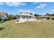 Pleasant residential streetscape with a well-kept lawn, nice landscaping and an attractive color palette at 1929 New Bedford Dr, Sun City Center, FL 33573