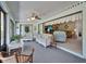 Bright Florida room with sliding doors, ceiling fan, and comfortable seating area with tropical decor at 1929 New Bedford Dr, Sun City Center, FL 33573