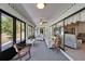 Bright Florida room with sliding glass doors, ceiling fan and comfortable seating overlooking the lawn at 1929 New Bedford Dr, Sun City Center, FL 33573