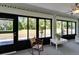 Cozy sunroom provides outdoor views, seating and access to the patio and backyard at 1929 New Bedford Dr, Sun City Center, FL 33573