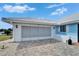 Spacious garage with modern doors and brick paver driveway at 1929 New Bedford Dr, Sun City Center, FL 33573