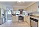 Open kitchen featuring stainless steel appliances, granite counters, and tile flooring at 1929 New Bedford Dr, Sun City Center, FL 33573