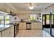 Clean and bright kitchen with granite countertops, stainless appliances, and tile flooring at 1929 New Bedford Dr, Sun City Center, FL 33573