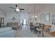 An open concept living room featuring vaulted ceilings with access to the dining area at 1929 New Bedford Dr, Sun City Center, FL 33573
