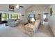 Cozy living room with vaulted ceiling, brick accent wall, and comfortable seating at 1929 New Bedford Dr, Sun City Center, FL 33573