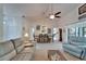 Bright living room featuring vaulted ceilings, plush sofas, and an elegant dining area at 1929 New Bedford Dr, Sun City Center, FL 33573