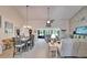 Open-concept living room with vaulted ceilings, and a view to the dining area at 1929 New Bedford Dr, Sun City Center, FL 33573