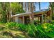 View of backyard shed surrounded by foliage. The perfect place to store all your outdoor gear at 20926 Ragan Ln, Land O Lakes, FL 34638