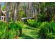 View of backyard shed among lush vegetation with walkway. Enjoy the wooded backyard and nature at 20926 Ragan Ln, Land O Lakes, FL 34638