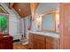 Charming bathroom with a vintage-style tub, wooden vanity, and striking wood ceiling at 20926 Ragan Ln, Land O Lakes, FL 34638
