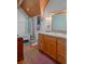 Charming bathroom with a vintage-style tub, wooden vanity, and striking wood ceiling at 20926 Ragan Ln, Land O Lakes, FL 34638