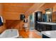 Bright bathroom featuring wood paneling, soaking tub, walk-in shower, and modern vanity at 20926 Ragan Ln, Land O Lakes, FL 34638