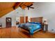 Bedroom with hardwood floors, a queen size bed, exposed ceiling beams, and wooden furnishings at 20926 Ragan Ln, Land O Lakes, FL 34638