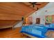 Upstairs bedroom featuring vaulted ceilings, exposed beams, a queen bed, and hardwood floors at 20926 Ragan Ln, Land O Lakes, FL 34638