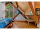 Bedroom with exposed beam ceilings, wall to wall windows and view of the wooded property at 20926 Ragan Ln, Land O Lakes, FL 34638