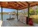 View of the peaceful lake from the spacious covered dock, perfect for lakeside living at 20926 Ragan Ln, Land O Lakes, FL 34638