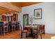 Dining space featuring a table, chairs, a breakfast bar, and a glimpse of outdoor scenery at 20926 Ragan Ln, Land O Lakes, FL 34638