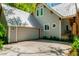 Side exterior showcasing an attached garage and beautiful architectural details at 20926 Ragan Ln, Land O Lakes, FL 34638